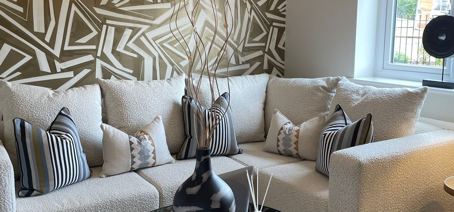 Cream corner sofa with geometric style wallpaper