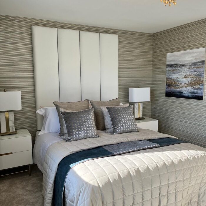 Cool grey and beige toned bedroom with double bed and side tables