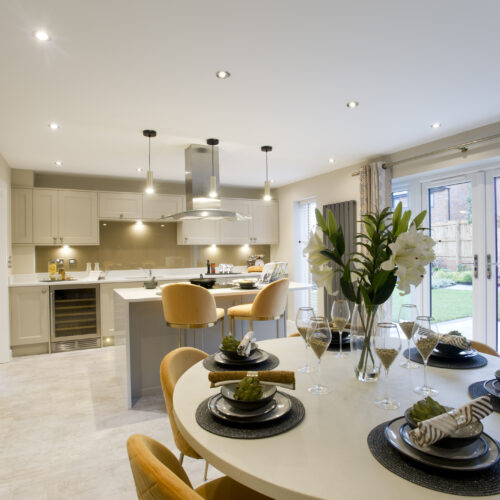 Cream showhome kitchen with yellow furnishing accents