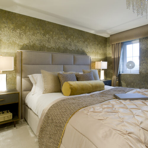 Light green themed show home bedroom with patterned wallpaper and beige accents